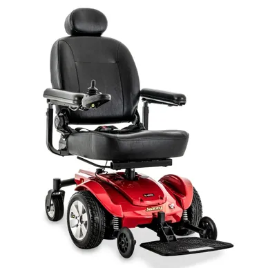 A red and black motorized wheelchair with padded seat and armrests.