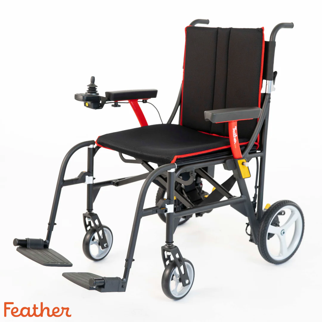 Lightweight, foldable wheelchair with black cushioning and red accents.