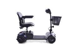 Compact mobility scooter with a basket and armrests.