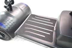 A stainless steel grill pan with ridges beside a pot.