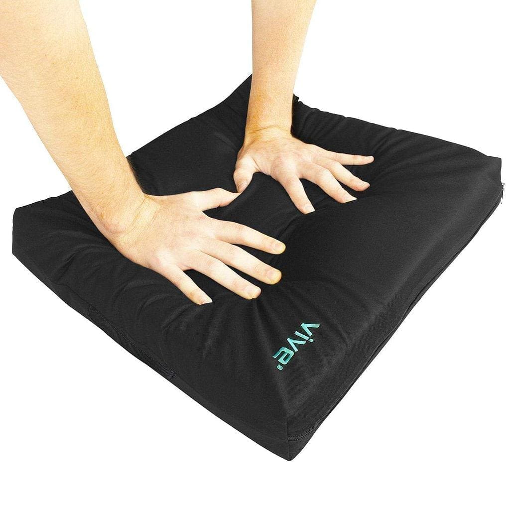 A person is holding their hands on the cushion.
