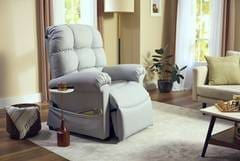A white recliner sitting in the middle of a living room.