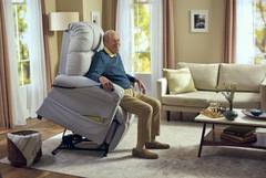 A man sitting in an electric lift chair.