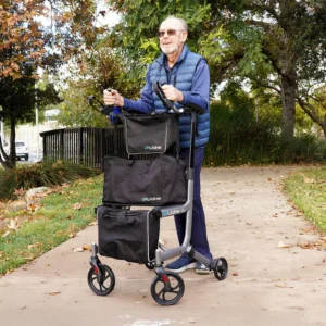 A man pushing a cart down the sidewalk.