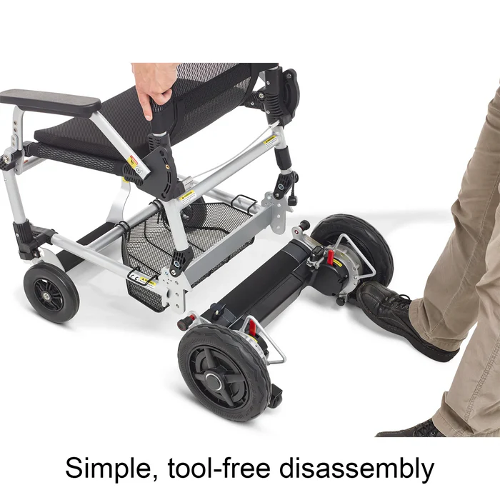A man pushing a wheelchair on wheels.