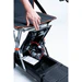 Person adjusting a modern wheelchair with footrests and a sleek design.