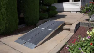Portable wheelchair ramp set up on outdoor steps.