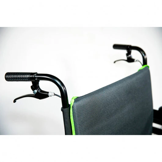 Close-up of a wheelchair's handle and backrest with green edging.