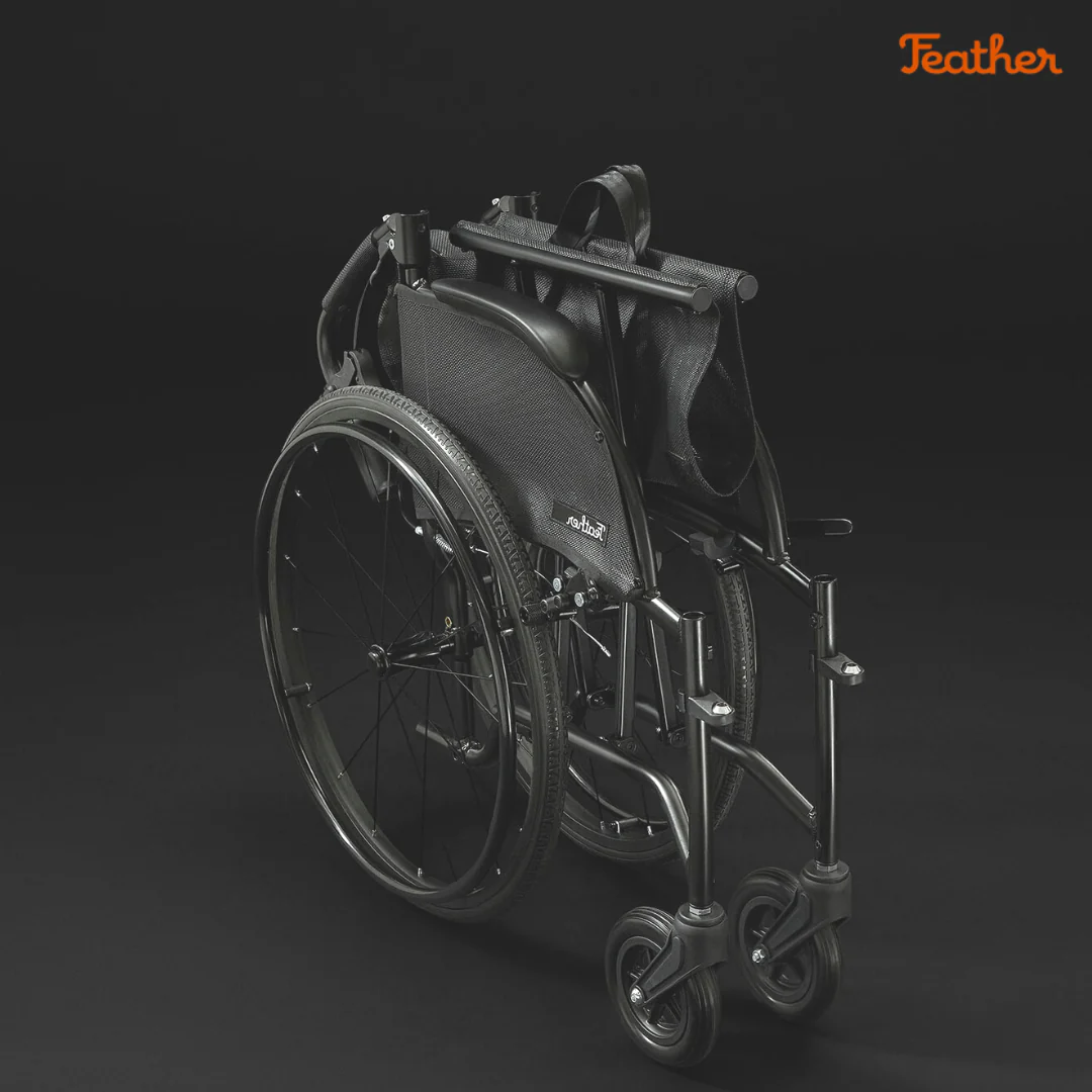 A sleek, modern wheelchair with a black matte finish against a dark background.