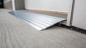 Aluminum wheelchair ramp installed over concrete surface.