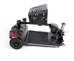 A black motorized golf trolley with a battery and handle.