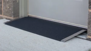 A partially installed black carpet or rug on a floor.