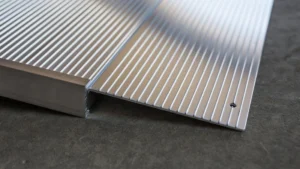 Close-up of metallic stair edge protection with anti-slip ridges.