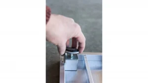 Hand adjusting a sliding glass door lock.