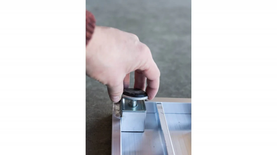 Hand adjusting a sliding glass door lock.