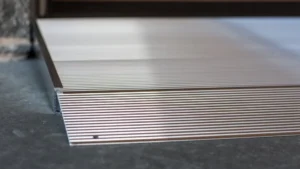 Stacked corrugated metal sheets on a concrete floor.