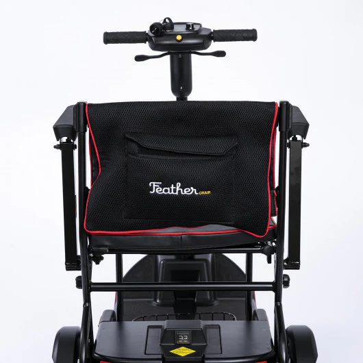 Black mobility scooter with a front storage bag and handlebars.