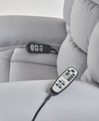 Two TV remotes placed on a light-colored sofa.