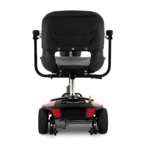 Rear view of a black and red mobility scooter with a padded seat and armrests.