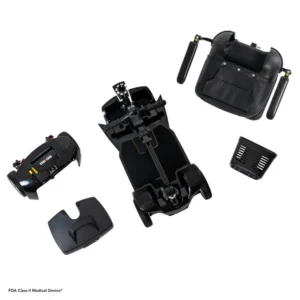 Disassembled black mechanical or electronic device parts isolated on white.