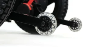 Close-up of a transparent stabilizer wheel on a child's bicycle.