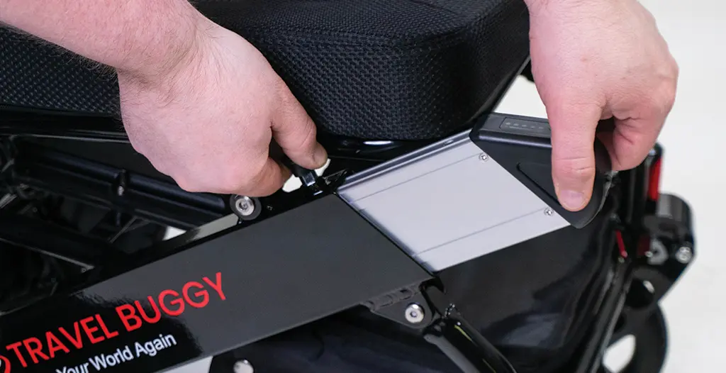 Close-up of hands adjusting a black electronic device.