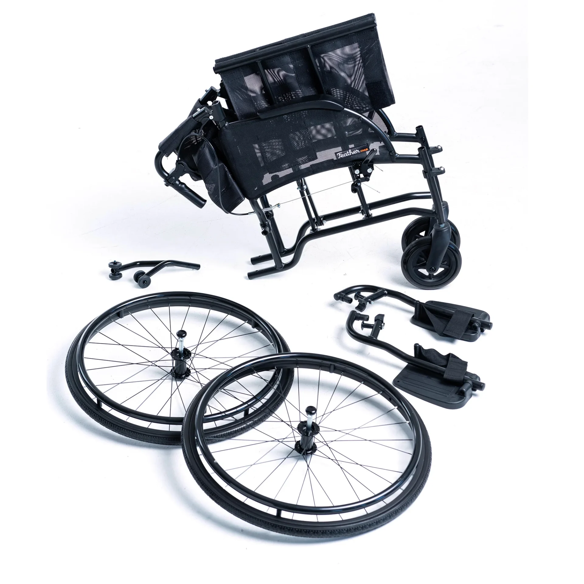 Disassembled black wheelchair with wheels and footrests.