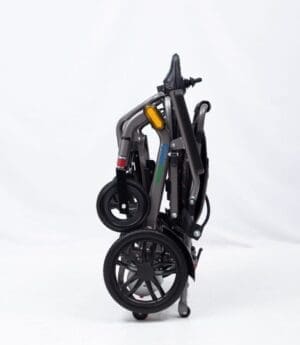 Folded black stroller with large wheels against white background.