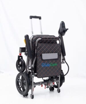 Folded electric wheelchair with a handle for easy transport.