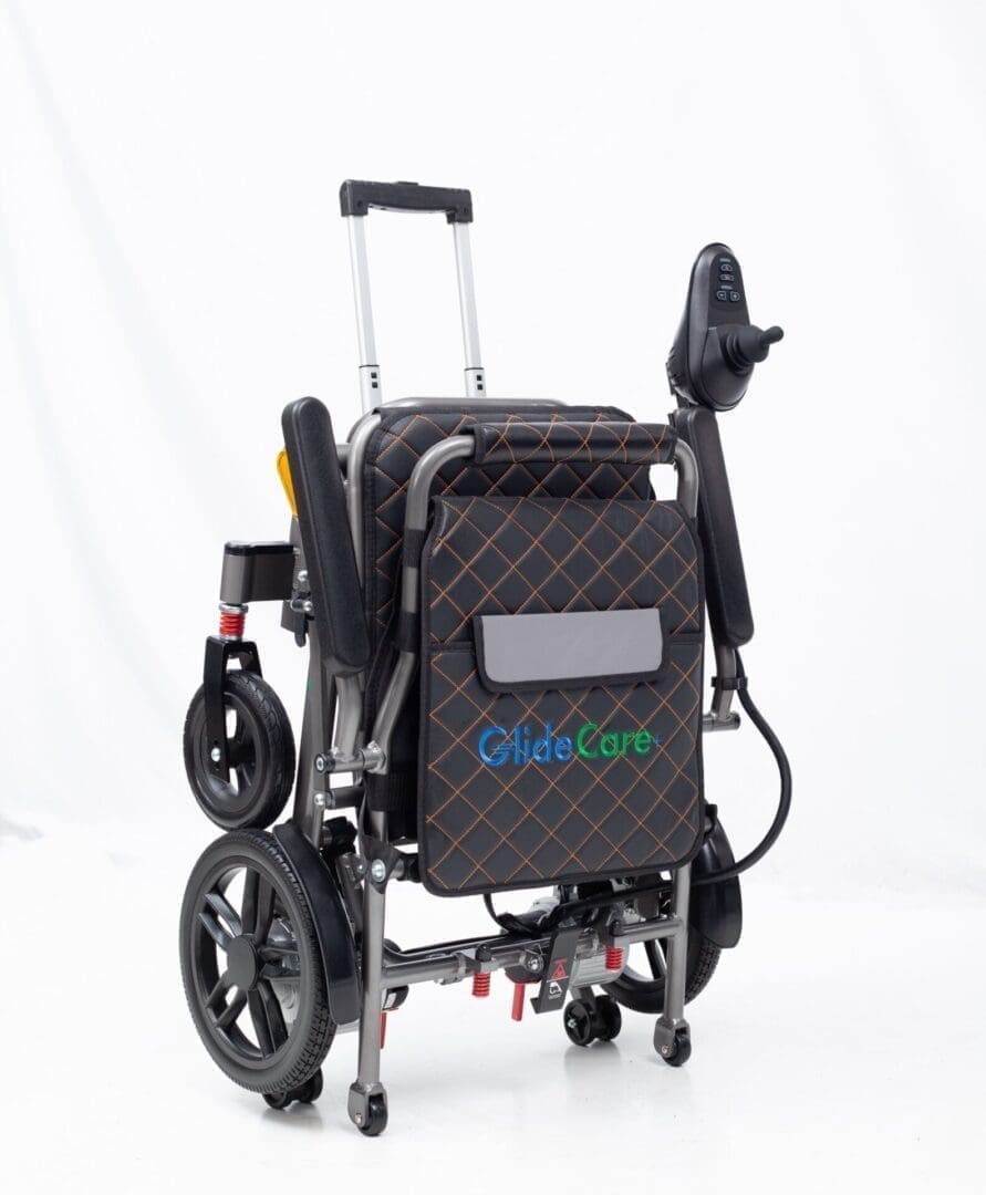 Folded electric wheelchair with a handle for easy transport.