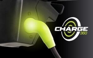 Close-up of a glowing green electric vehicle charging plug.