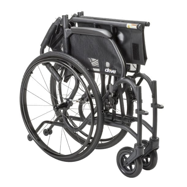 Folded black wheelchair ready for transport or storage.