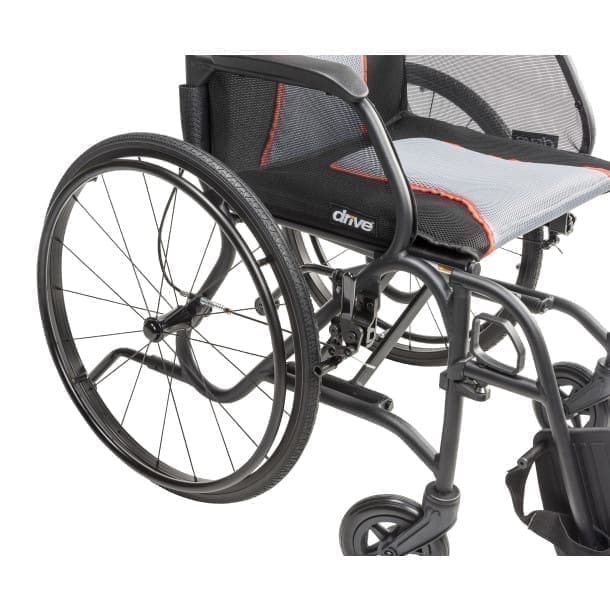 Modern manual wheelchair with large rear wheels and cushioned seat.