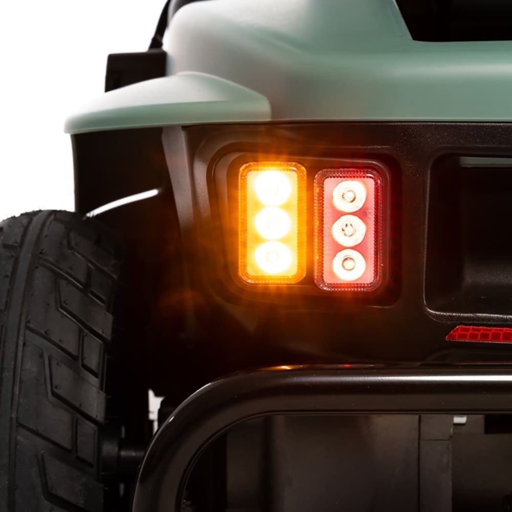 Close-up of a vehicle's rear light with amber turn signal illuminated.
