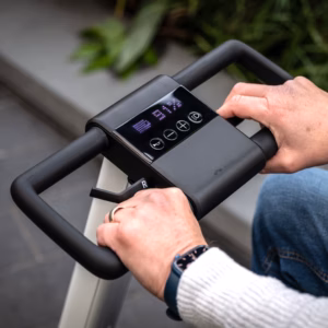 Person steering an electric scooter with a digital display.