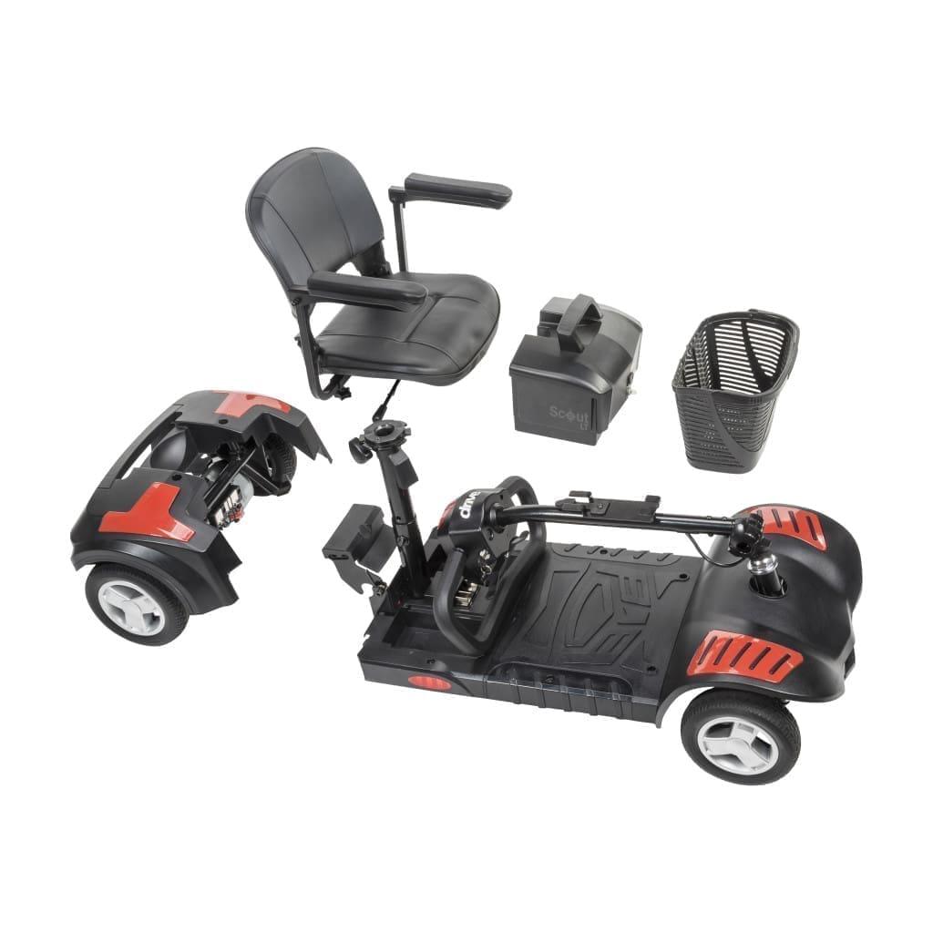 Disassembled mobility scooter with seat and battery parts.