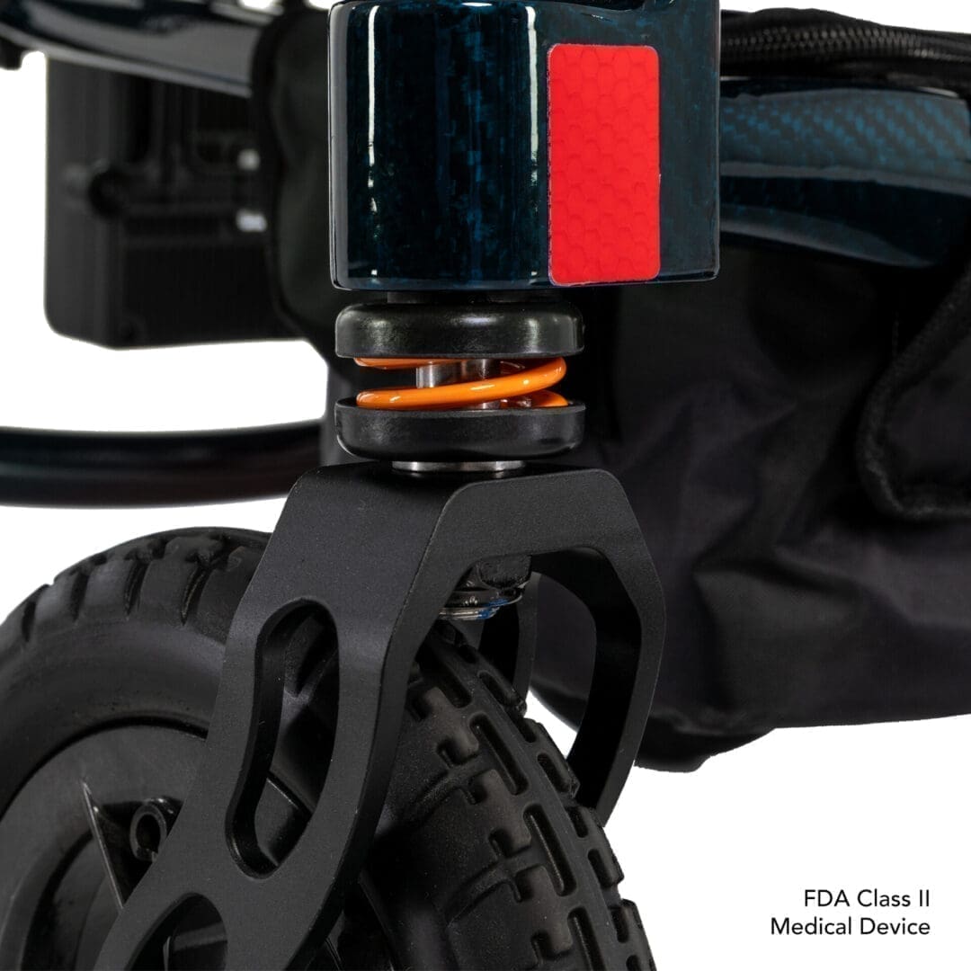 Close-up of a black electric scooter wheel and suspension system.