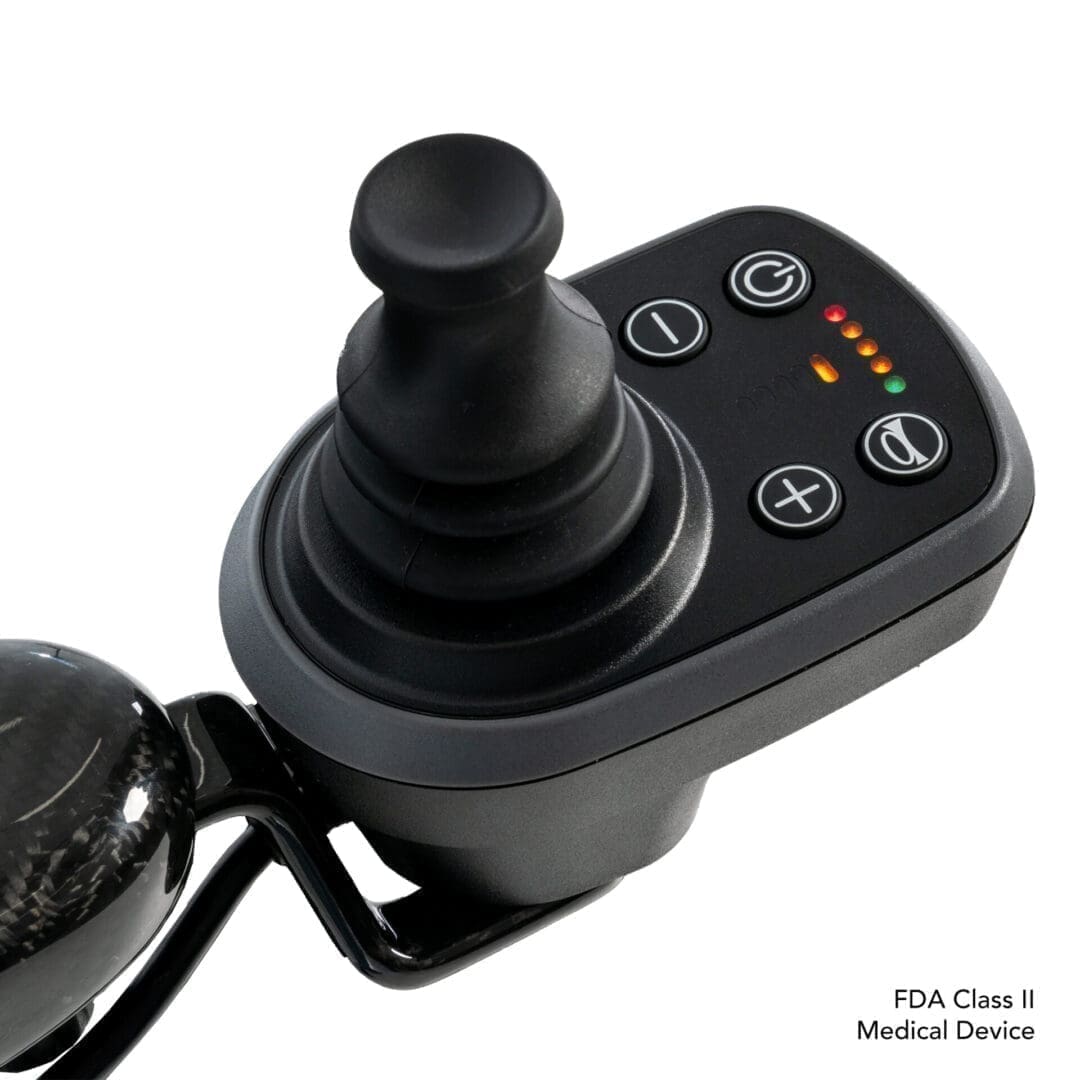 Close-up of a joystick control panel with buttons and a joystick.